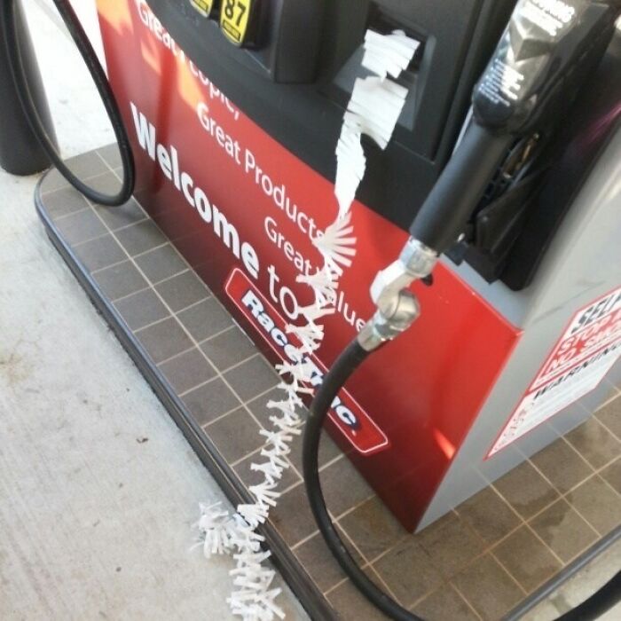 Gas station receipt unspooling dramatically from the pump, capturing interesting receipts people found.