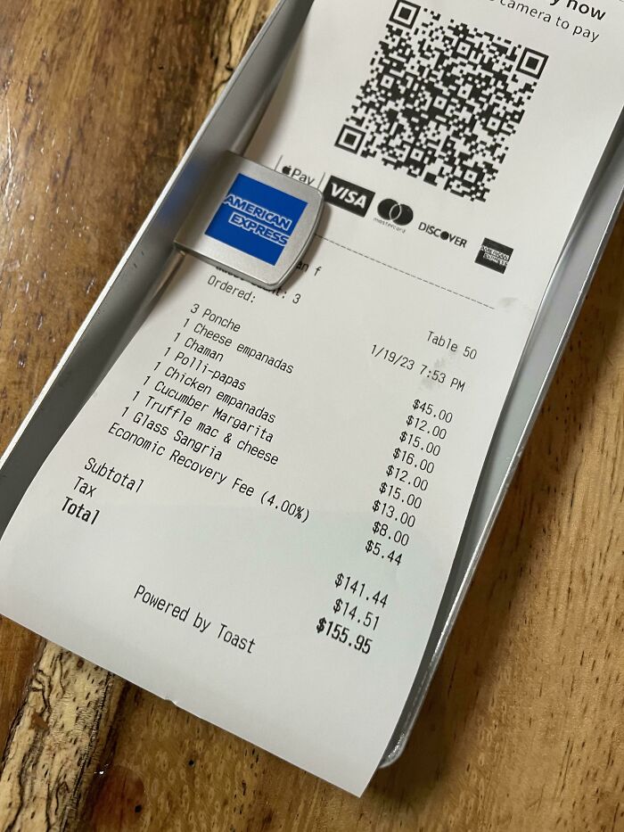 Receipt with various food items and total, highlighting interesting finds on a wooden table.