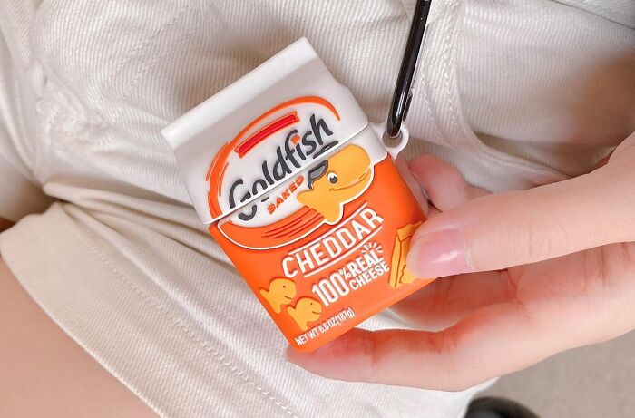 Hand holding a quirky Goldfish Cheddar purse, injecting goofiness into the day.