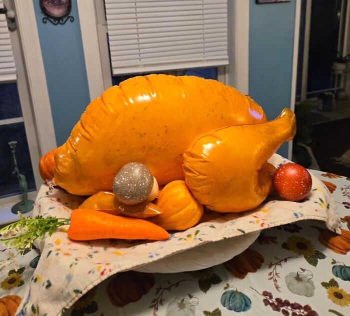 Inflatable turkey centerpiece with carrots and ornaments, showcasing quirky Archie Mcphee items in a dining room setting.