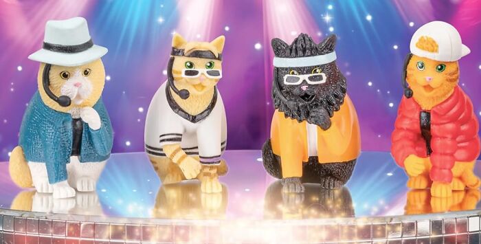 Four Archie Mcphee items: toy cats dressed as pop stars on a shiny stage with vibrant lights.