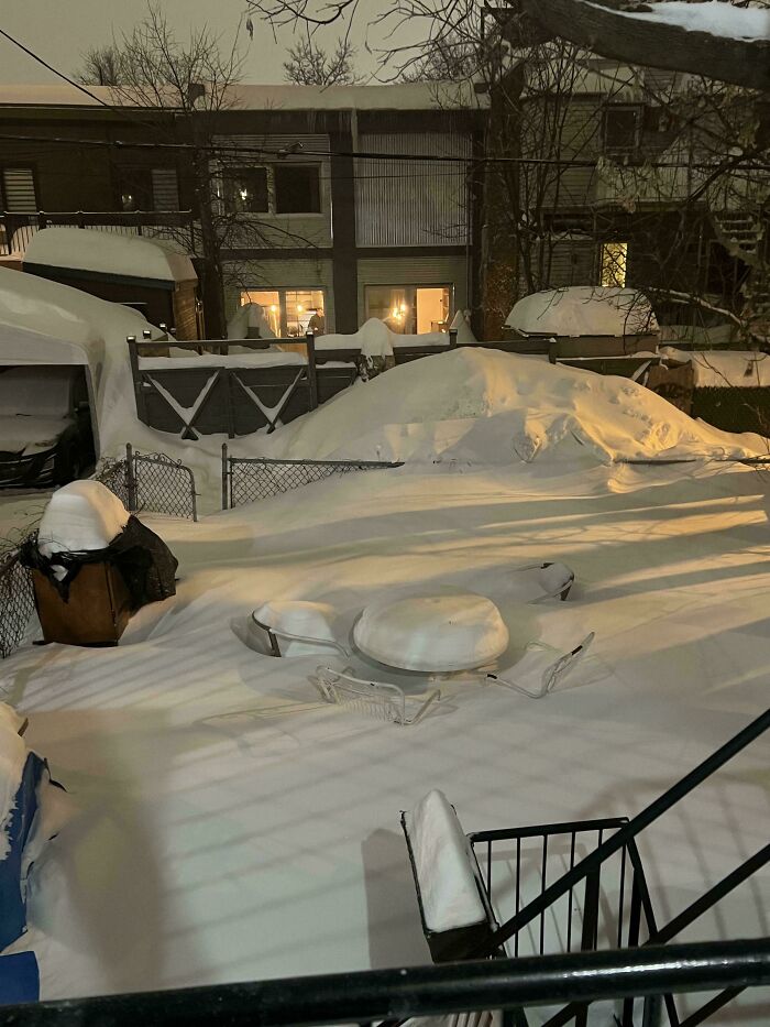 Snow-covered backyard with patio furniture, showcasing winter wonderland vibes. Just-Canada-Things exemplified.