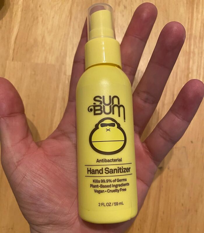 Hand holding Sun B*m antibacterial hand sanitizer, product to simplify daily life.