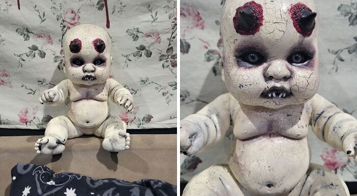 Creepy handmade doll with c*****d skin and horns, sitting against a floral background.