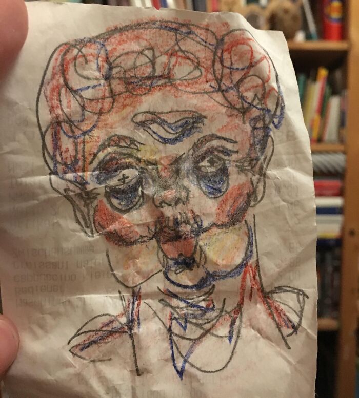 Crayon sketch of a face on a crumpled paper receipt, illustrating an interesting receipt people found.