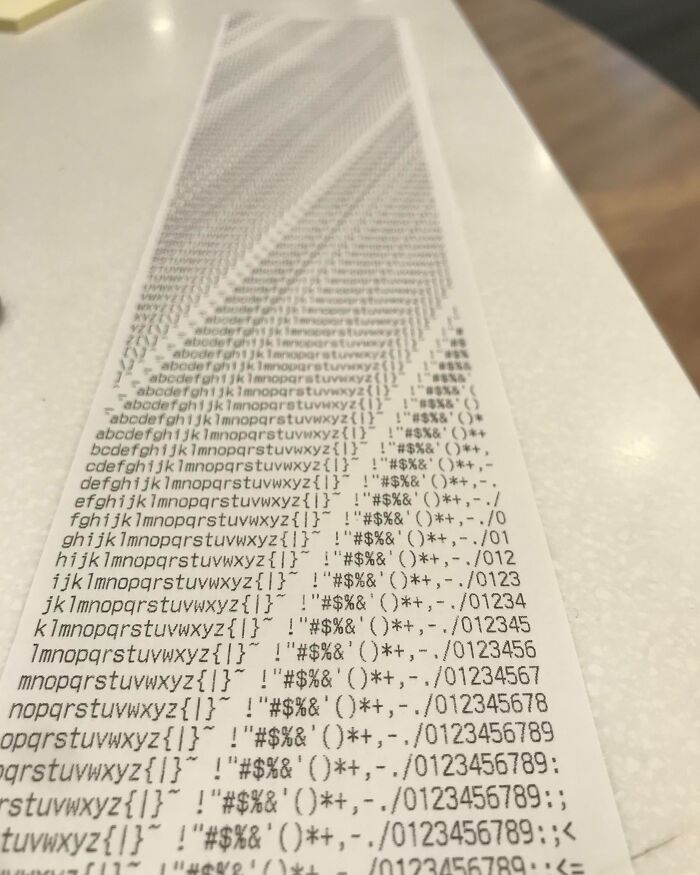 A long receipt with a pattern of repeated letters and symbols, showcasing one of the interesting receipts people found.