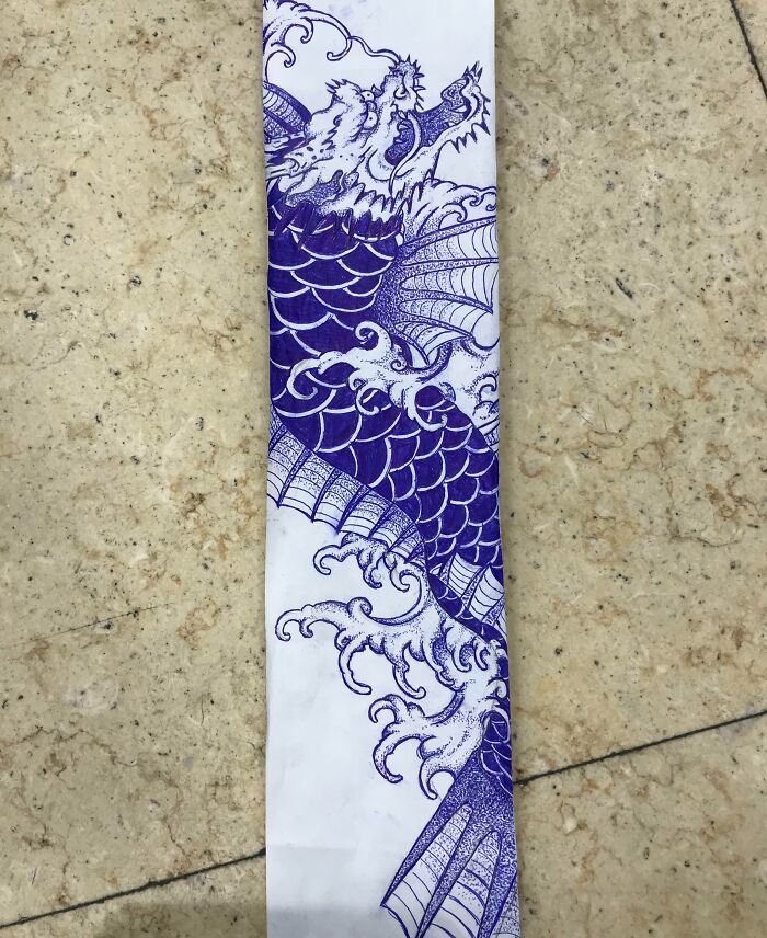 Unique receipt with intricate blue dragon design found on a textured surface.