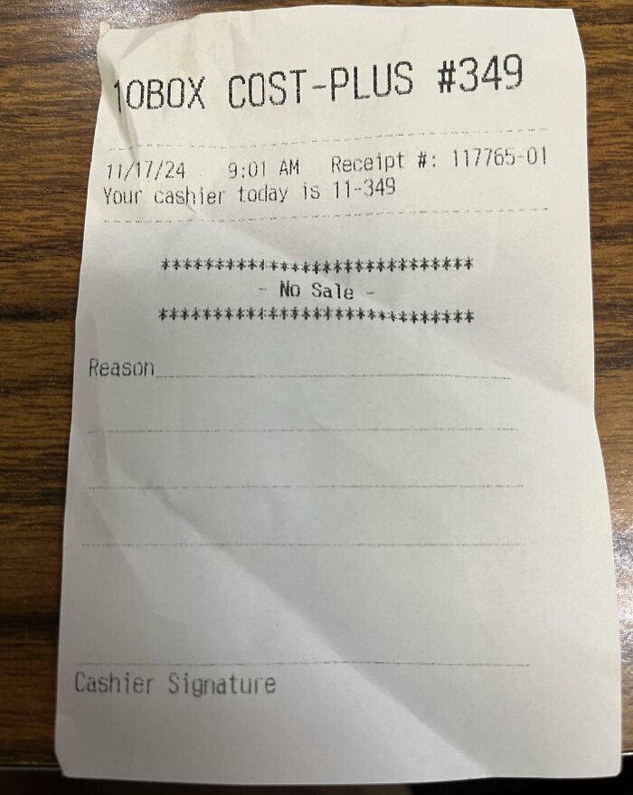Receipt with "No Sale" printed, found by people, showing store name and cashier info on wooden background.