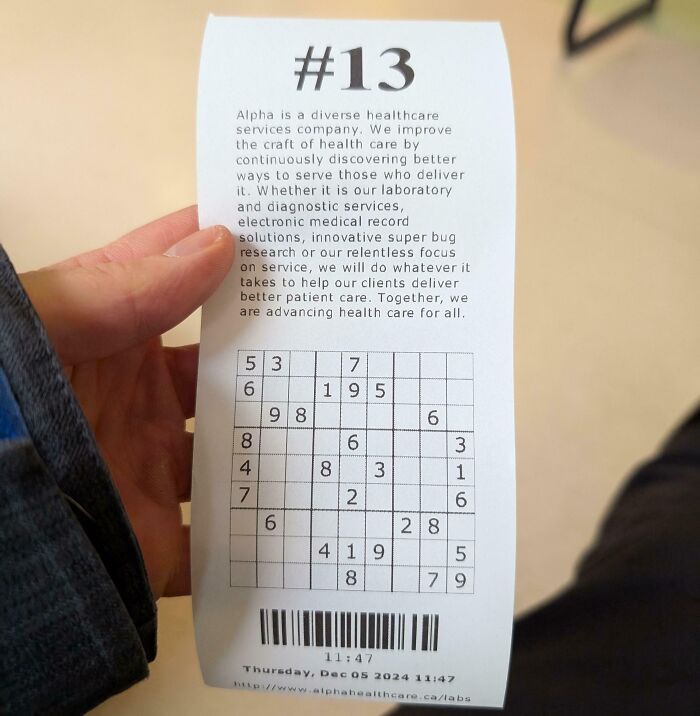 Person holding an interesting receipt with a detailed message and a Sudoku puzzle at the bottom.