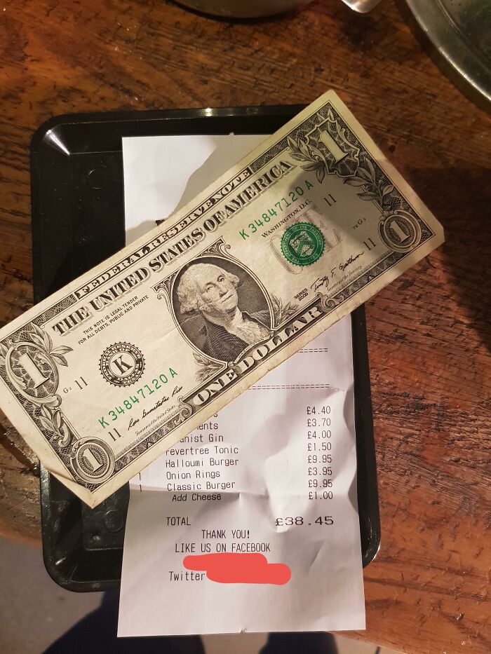 Dollar bill left as tip on a receipt, mildly infuriating server experience.