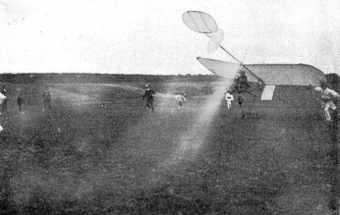 Inventor testing an early aircraft with large wings in an open field, a creation leading to personal downfall.