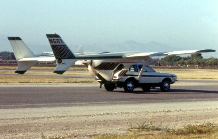 Inventor's creation: a small car attached to an aircraft on a runway, illustrating inventive yet risky innovation.