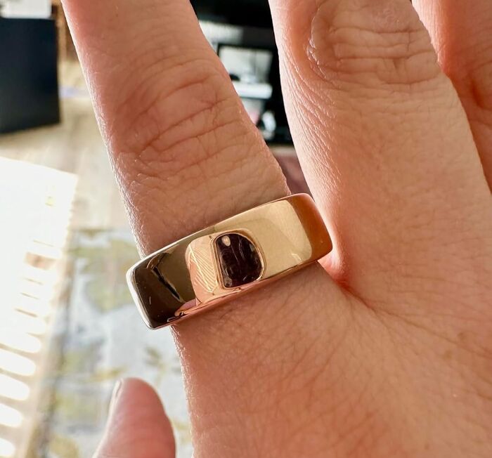 Gold ring on a finger, an impulse buy that proved valuable.