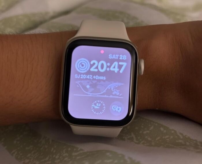 Smartwatch illuminating with purple display, an example of impulse buys worth it.