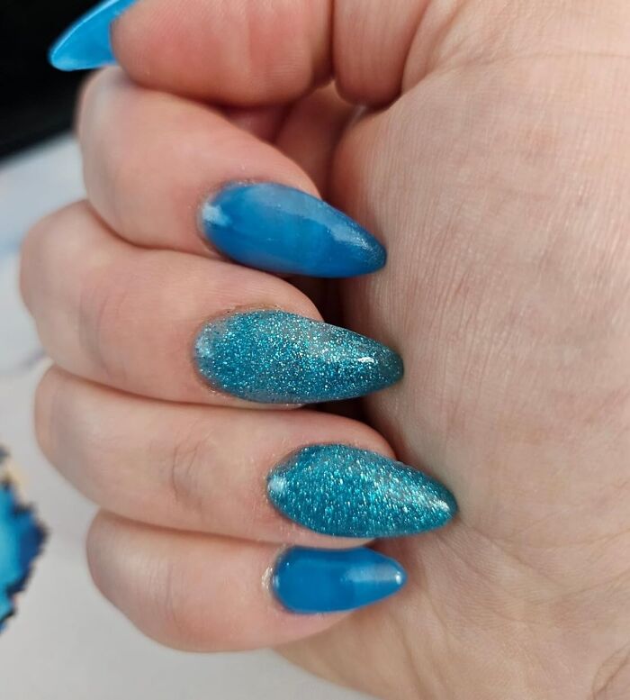 Blue glittery nails showing a successful impulse buy decision.