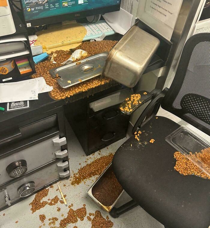Spilled beans on a messy office desk, illustrating a chaotic moment in food service industry work.