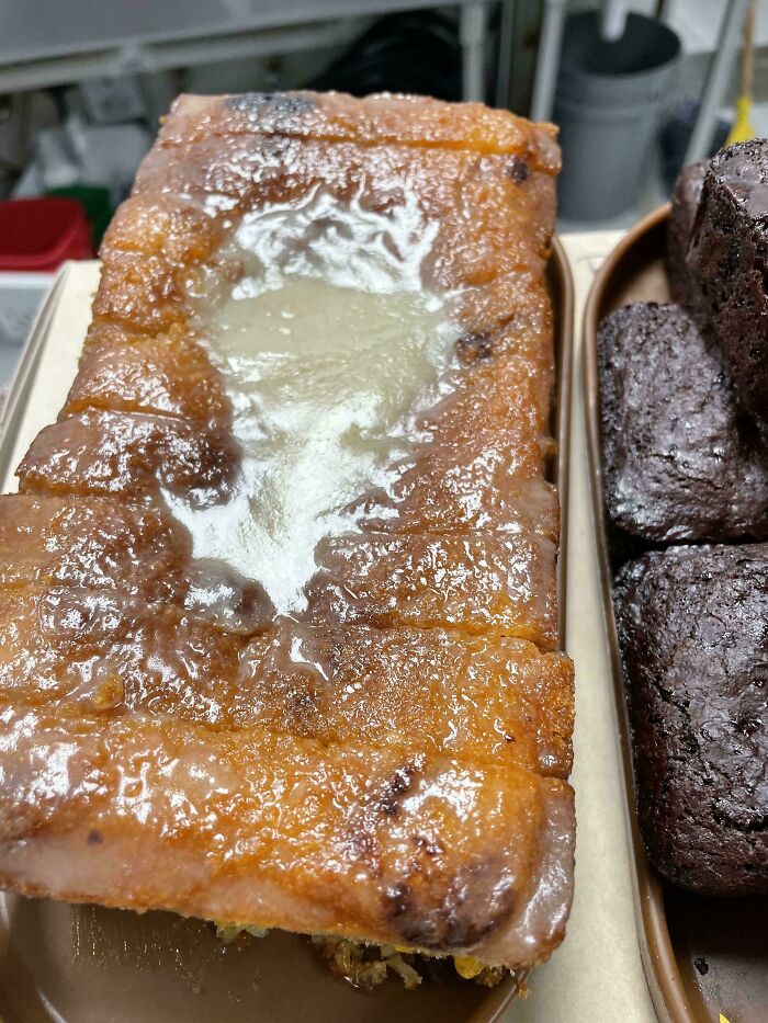 Close-up of a glazed pastry in a food service kitchen setting.