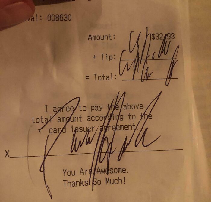 Receipt with unclear writing on tip line, under amount $32.98, illustrating mildly infuriating server tips.