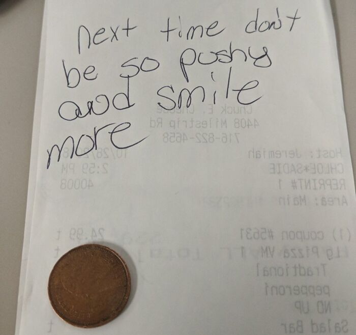 A receipt with a penny tip and handwritten note, representing mildly infuriating server tips.