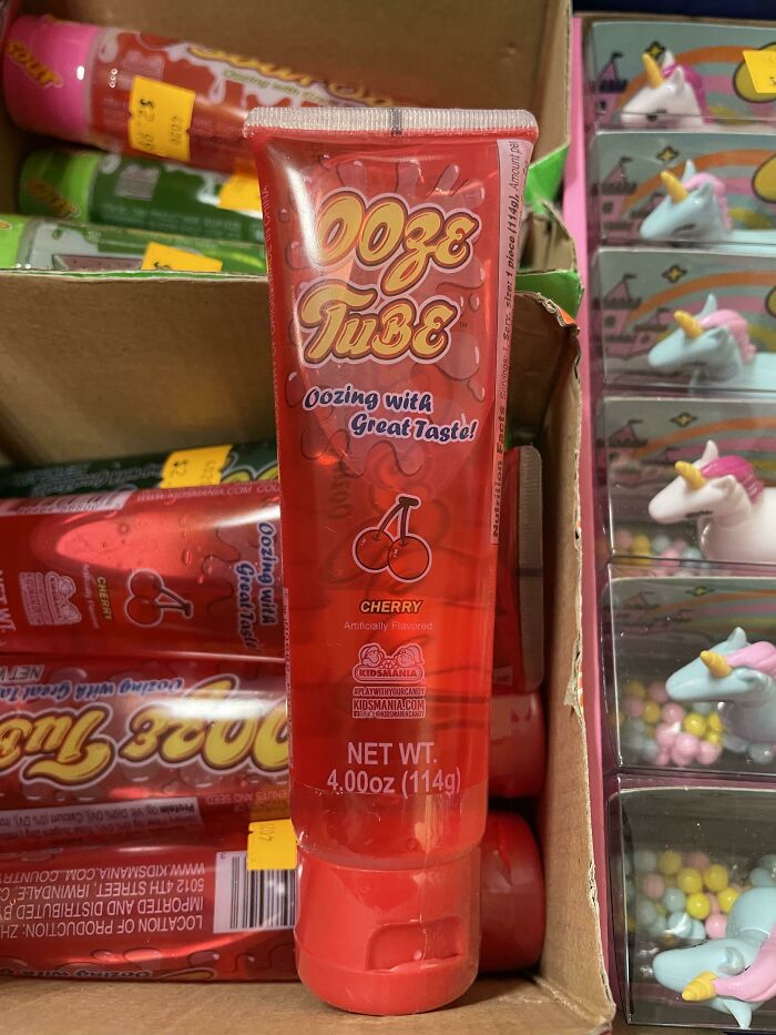 90s and 2000s food item, Ooze Tube candy, cherry flavor, displayed in a cardboard box with colorful packaging.