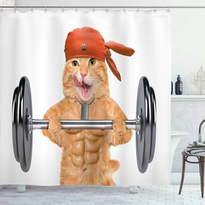 Cat with muscular body lifting weights, wearing a red bandana. Weird things concept shower curtain.