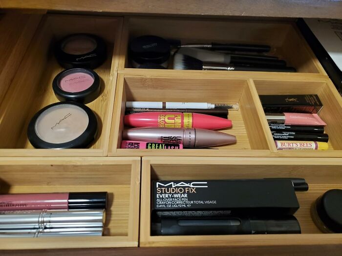 Makeup neatly organized in a wooden drawer, providing a spring cleaning headstart for cosmetics.