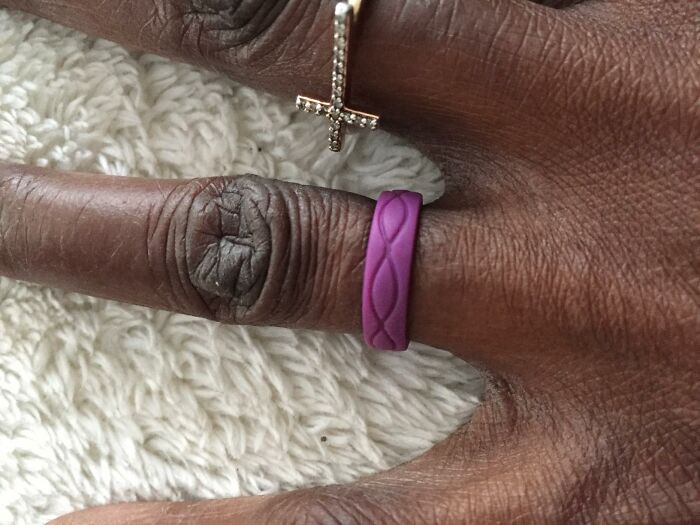 Purple silicone ring on dark-skinned hand, showcasing unique Sharktank items.