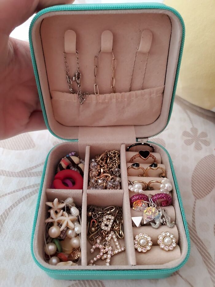 Jewelry organizer with various earrings, rings, and necklaces illustrating things under 5 dollars to save that coin.