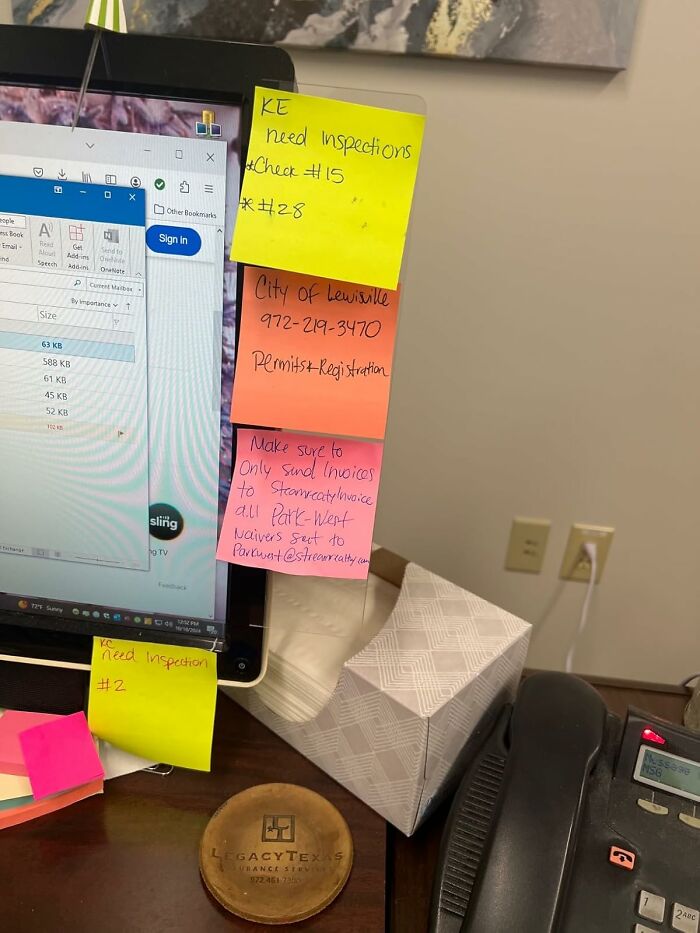 Workspace with sticky notes on a monitor, showcasing work from home tech essentials.
