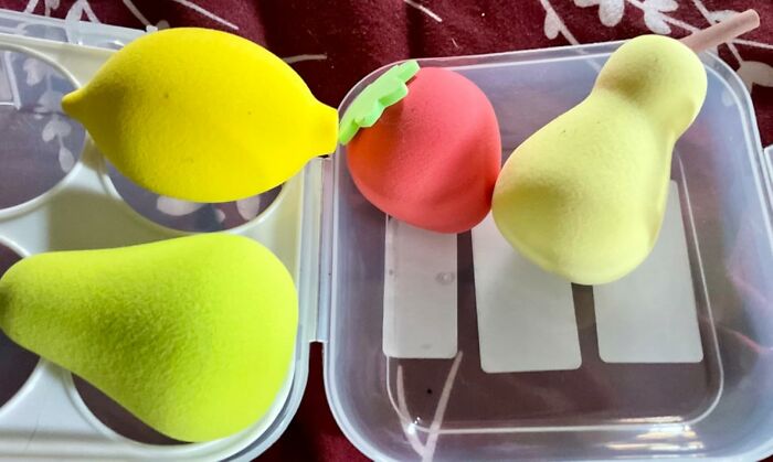 Colorful foam fruit toys to add goofiness to your day, including a lemon, strawberry, and pear in a plastic container.