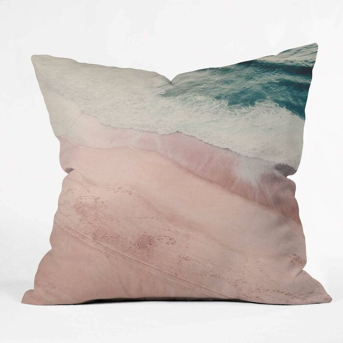 Decorative pillow from Society 6 featuring an aerial beach design with waves and sand.