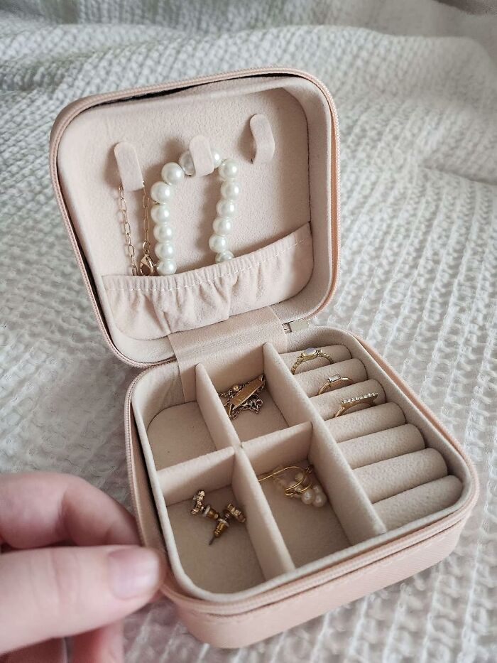 Compact jewelry case with mini accessories, ideal for minimalist packing in a carry-on.