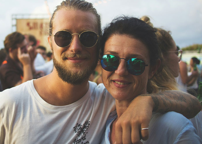 A man and woman smiling outdoors, wearing sunglasses, with "Chilling Last Words" theme.