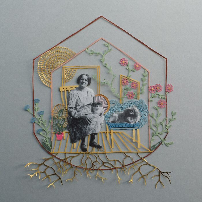 Intricate paper art design by Pippa Dyrlaga depicting a woman and a dog surrounded by flowers and roots.