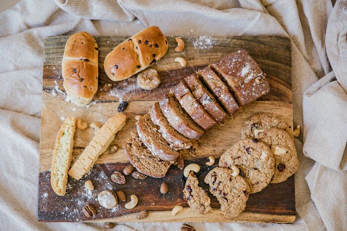 Assorted baked goods on a wooden board, showcasing variety and texture; concept related to fitness myths in diet.