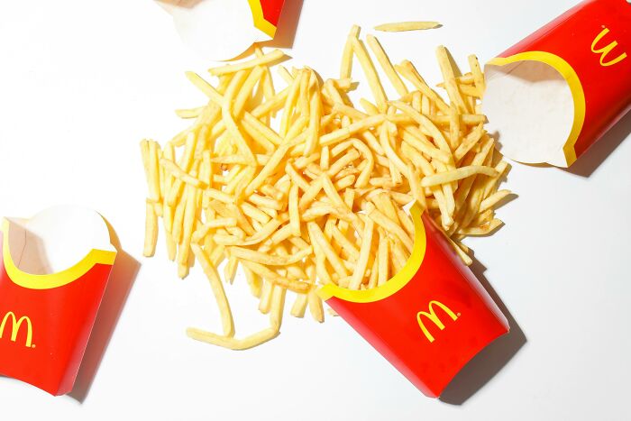 Red McDonald's fry containers with fries scattered, relating to pop culture moments.