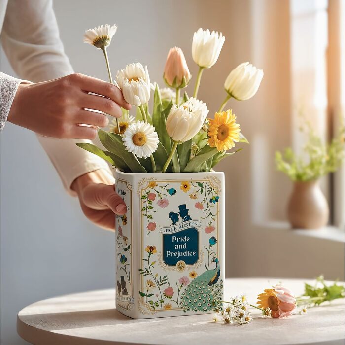 Decorative book-themed vase with flowers, an ideal Galentines Day gift for book lovers.