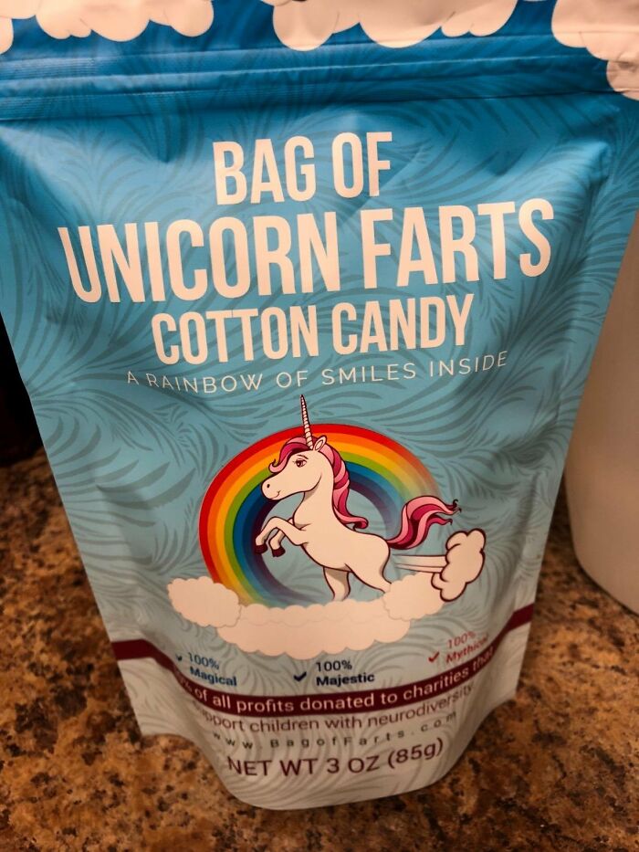 Unicorn-themed cotton candy bag with whimsical design, labeled "Unicorn Farts," placed on a countertop.