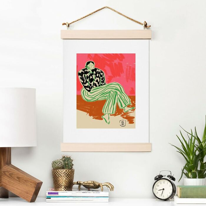 Art print from Society 6 displayed above a lamp and plants on a shelf.
