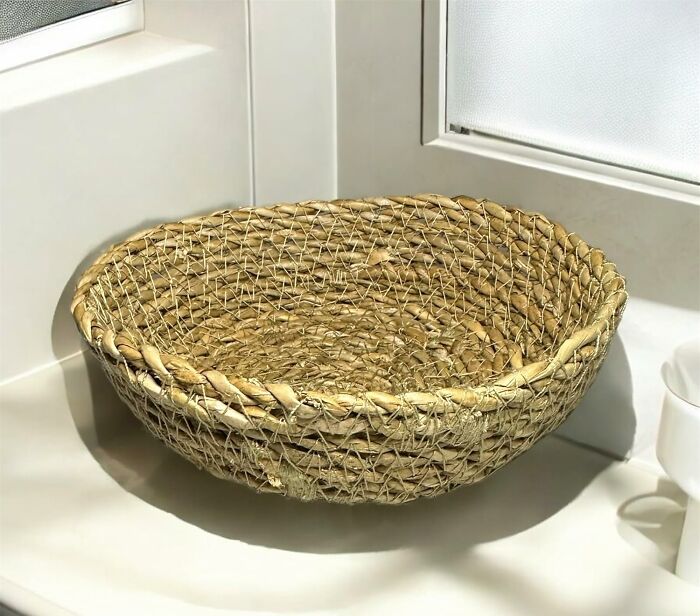 Handwoven basket on a windowsill, showcasing natural textures in 2025 interior trends.