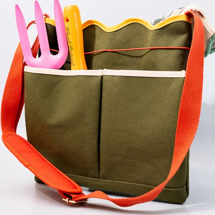 Olive green gardening tote from Bando on Amazon with orange strap, pink fork, and yellow garden tool.