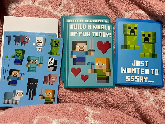 Minecraft-themed Valentine's Day cards for kids on a pink blanket.
