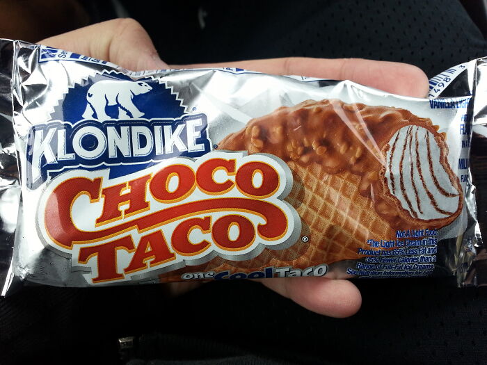 A Choco Taco ice cream, a nostalgic food item from the 90s and 2000s, wrapped in its original packaging.