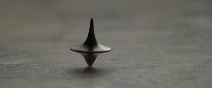 Spinning top movie prop on a smooth surface, showcasing iconic movie memorabilia.