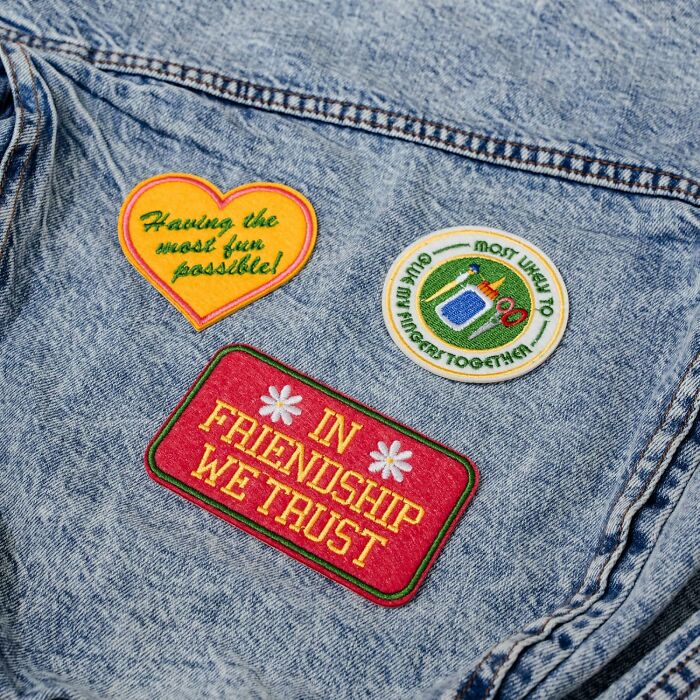 Denim jacket with colorful embroidered patches from Bando, featuring friendship and fun slogans.