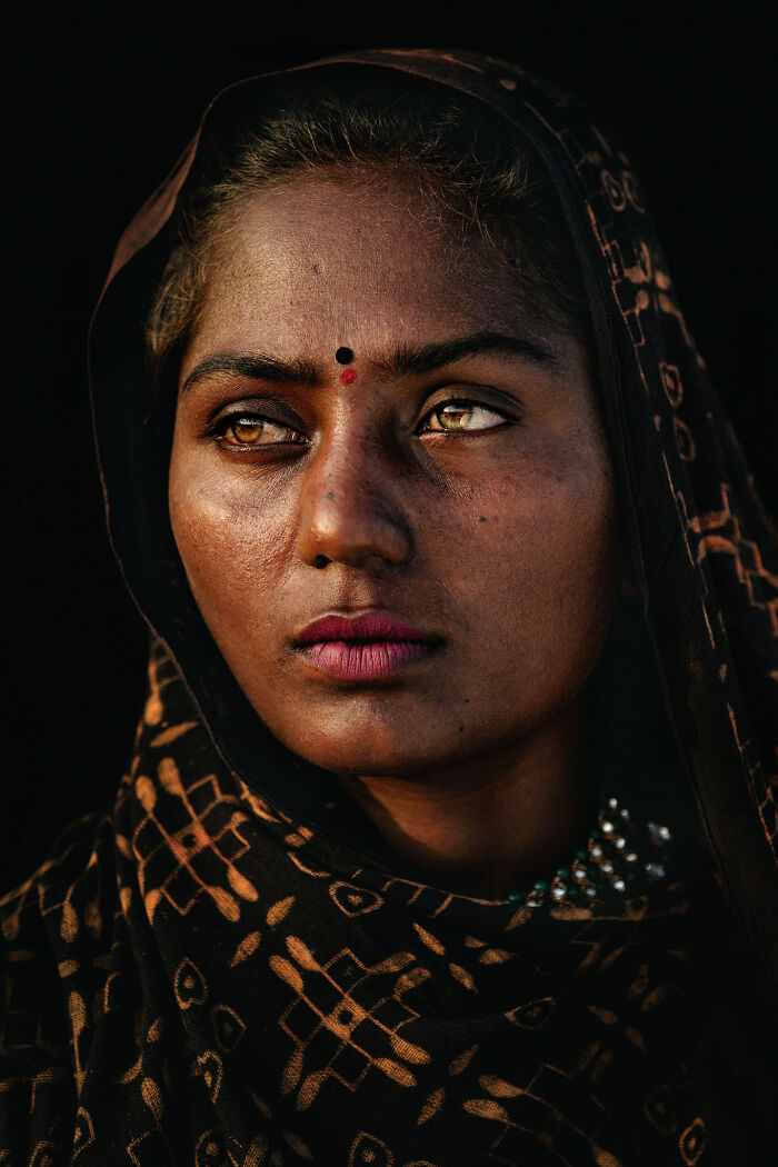 Expressive face captured in detailed portrait, wearing patterned shawl, eyes conveying deep emotion.