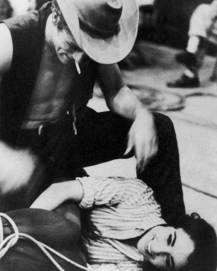 A joyful couple sharing a candid, intimate moment on set, capturing true happiness.