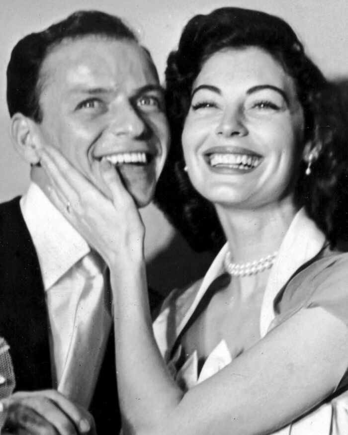 A joyful couple smiling together, capturing true happiness with genuine delight.