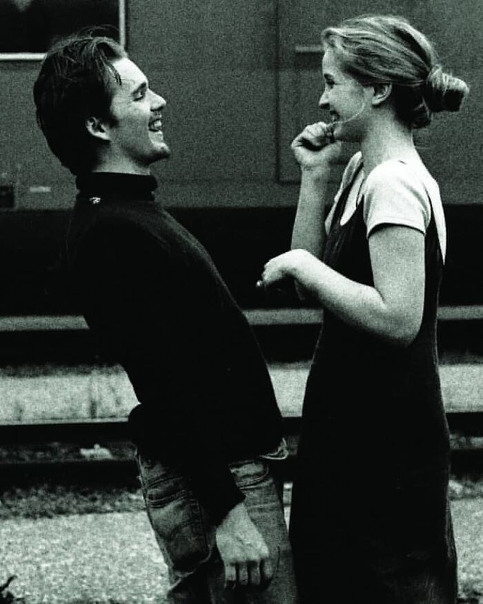 A joyful couple shares a laugh, capturing true happiness in a candid moment.