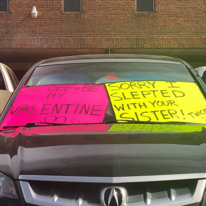 Car decorated with humorous signs for Valentine's Day fails.